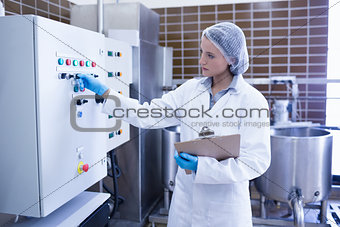 Focused biologist holding clipboard and pressing on button