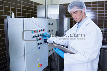 Focused biologist with safety gloves holding clipboard