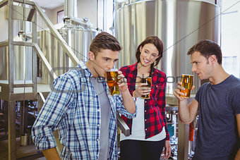 Young hipsters tasting beer together