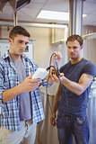 Two casual men testing beer in the beaker