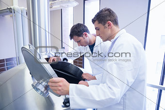 Two scientists looking into the container
