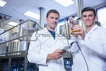 Men testing product and smiling at the camera