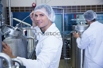 Portrait of a smiling scientist working with brewer