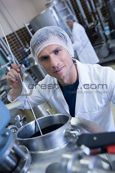 Smiling scientist using brewer in the container