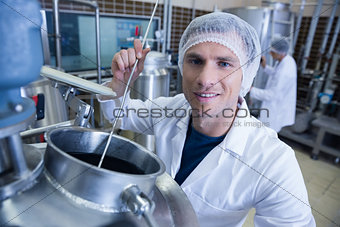 Smiling scientist using brewer in the container