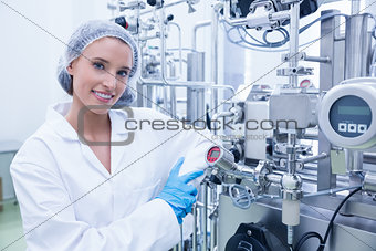 Smiling scientist leaning against gauge