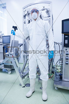Scientist in protective suit holding ladder