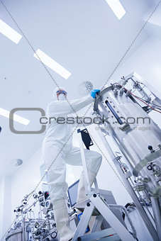 Scientist standing on ladder looking at the camera