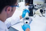 Close up of a chemist using a centrifuge
