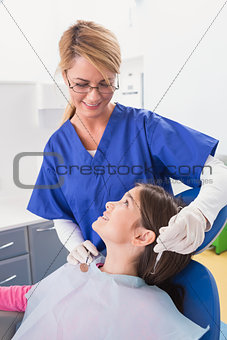 Smiling pediatric dentist with a happy young patient