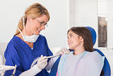 Smiling pediatric dentist reassuring her young patient