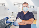 Portrait of a dentist with arms crossed and surgical mask