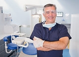 Portrait of a smiling dentist with arms crossed