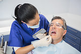 Dentist comparing teeth whitening