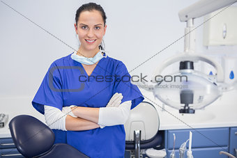 Portrait of a cheerful dentist with arms crossed