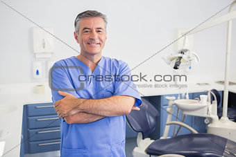 Portrait of a friendly dentist with arms crossed