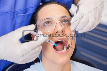 Dentist doing injection to his patient