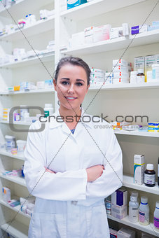 Portrait of a smiling student in lab coat with arms crossed