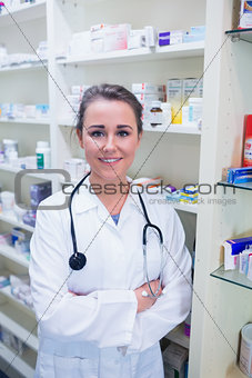 Student in lab coat with stethoscope and arms crossed