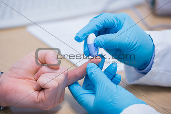 Doctor testing his patients blood