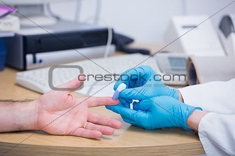 Close up of a doctor testing his patients blood