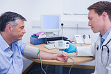 Doctor talking to his patient about his blood pressure