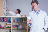 Concentrating pharmacist reading label on medicine jar