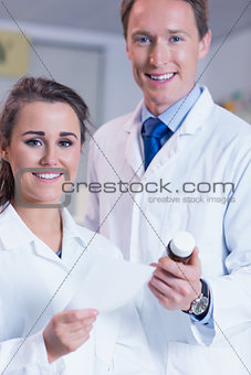 Pharmacist and his trainee looking at the camera