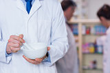 Close up of a pharmacist using mortar and pestle