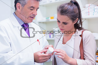 Pharmacist explaining something to a customer