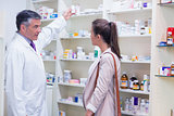 Pharmacist taking medicine in shelf