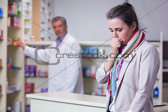 Portrait of a sick girl with scarf coughing