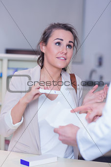 Shocked woman holding pregnancy test