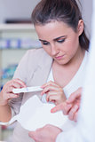 Young woman reading pregnancy test