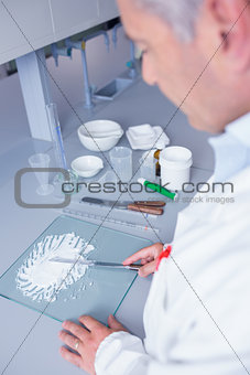 Biochemist standing while preparing some medicine