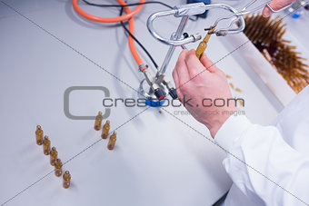 Close up of a biochemist sealing a vial