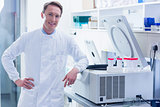 Smiling chemist leaning against the centrifuge