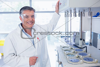 Smiling scientist with safety glasses