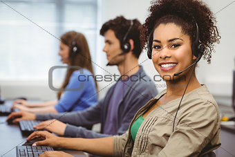 Smiling student with headset using computer