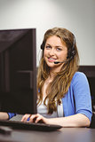 Student sitting at the computer room wearing headset