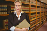 Serious lawyer holding a file while standing