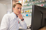 Focused pharmacist using the computer