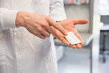 Pharmacist holding medicine blister pack