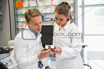 Team of pharmacists looking at medicine
