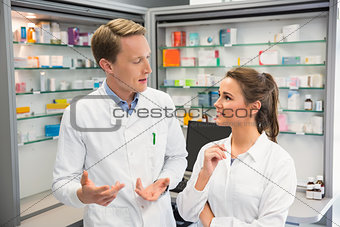 Team of pharmacists smiling and talking