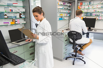 Team of pharmacists working on computers
