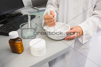Junior pharmacist mixing a medicine