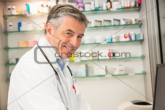 Senior pharmacist using the computer
