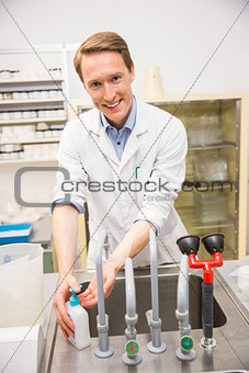 Handsome pharmacist washing his hands