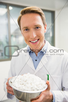 Pharmacist showing bowl of pills